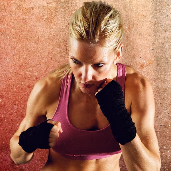 Mixed Martial Arts Lessons for Adults in Waco TX - Lady Kickboxing Focused Background