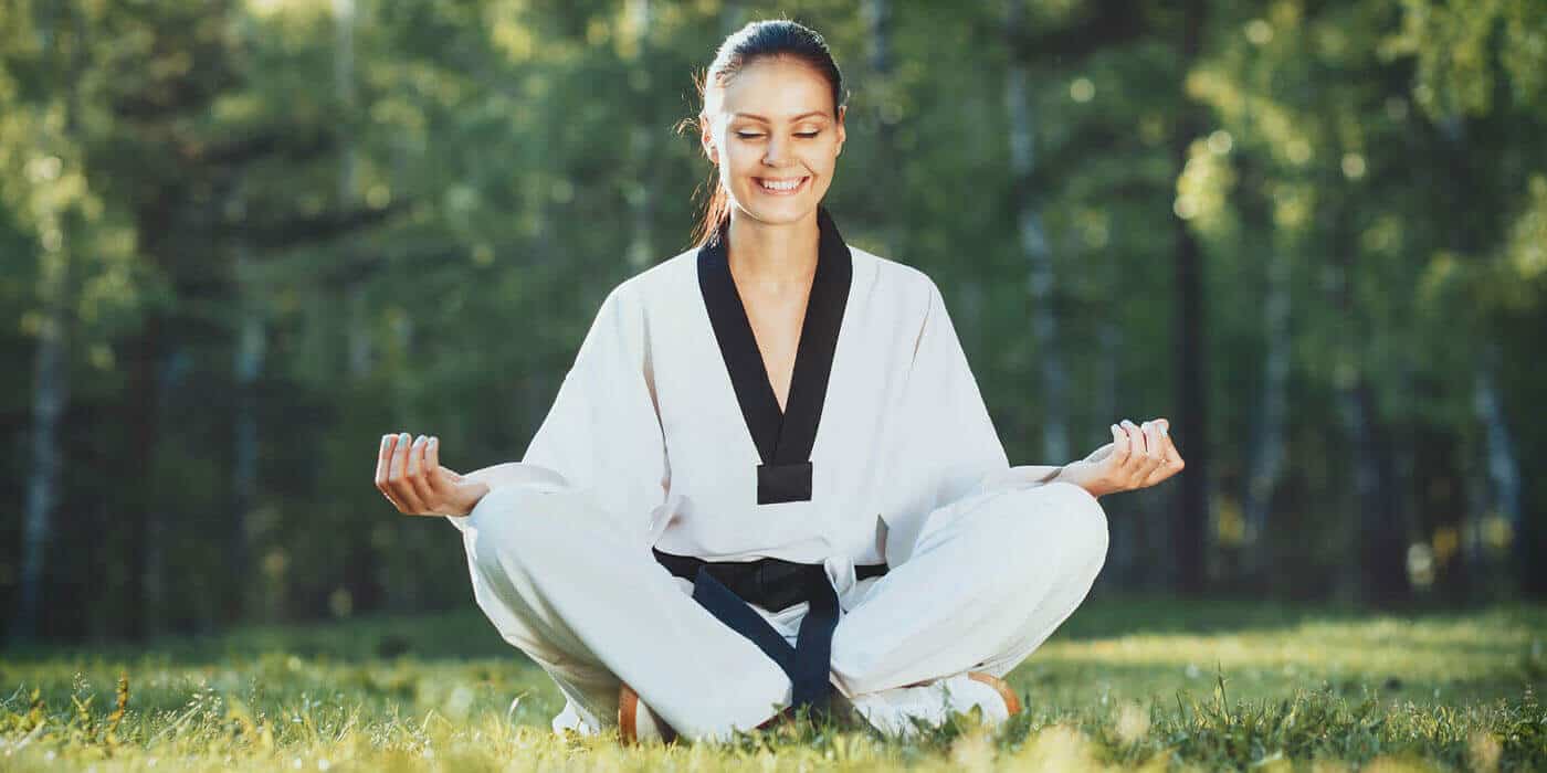 Martial Arts Lessons for Adults in Waco TX - Happy Woman Meditated Sitting Background